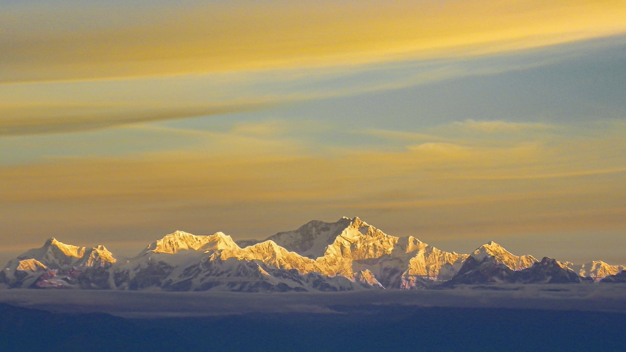 The Kanchenjunga range catching the first light above cloud